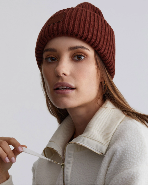 A woman in a brown knit hat and white sweater. [red/01]