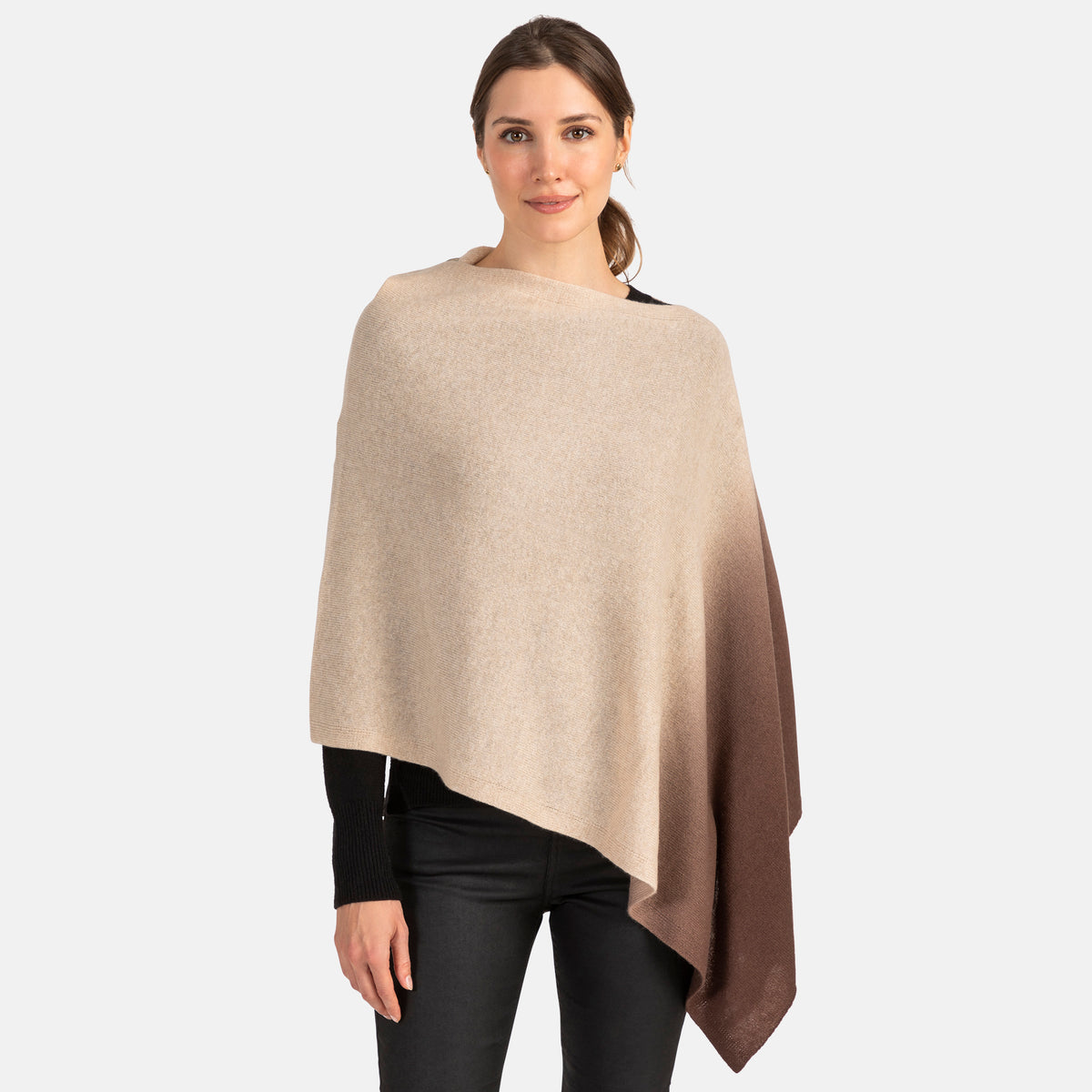Picture of a woman wearing an assymetrical cashmere knit over the head poncho with dip dye patter in grey and black.