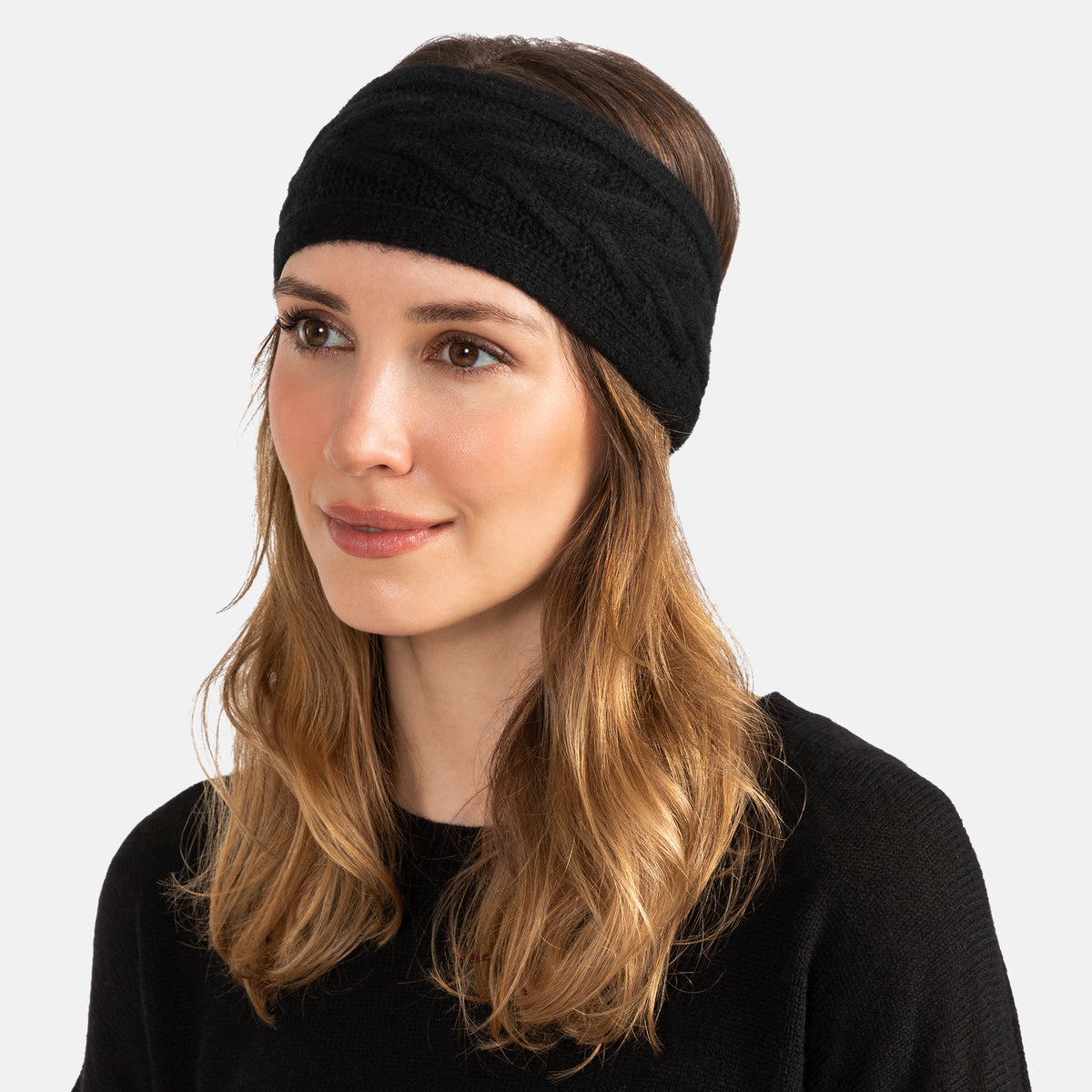 ture of a woman wearing a knitted cashmere headband with a trellis cable design in black.