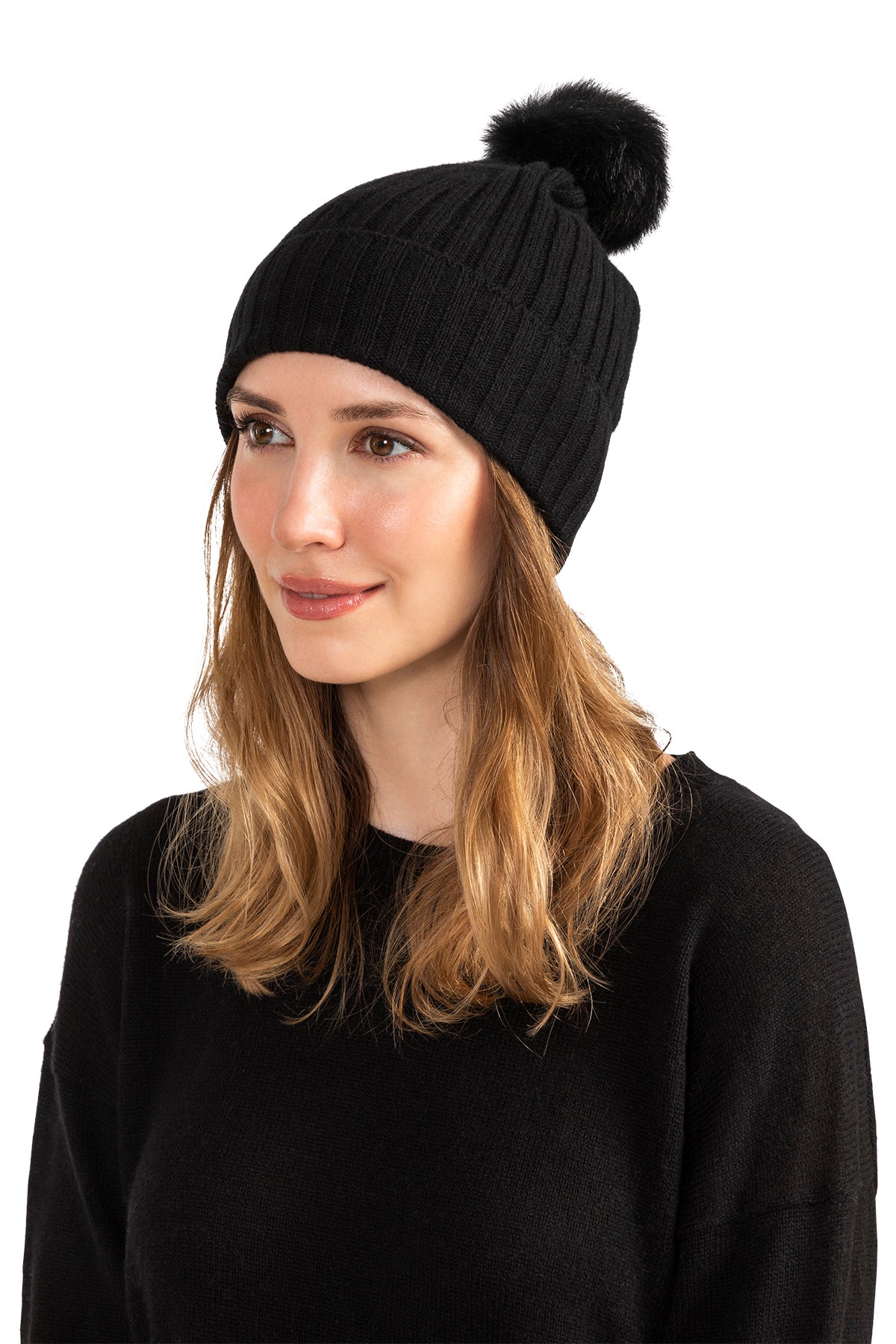 Woman wearing a Red cashmere beanie with shearling pom, rib knit detail.