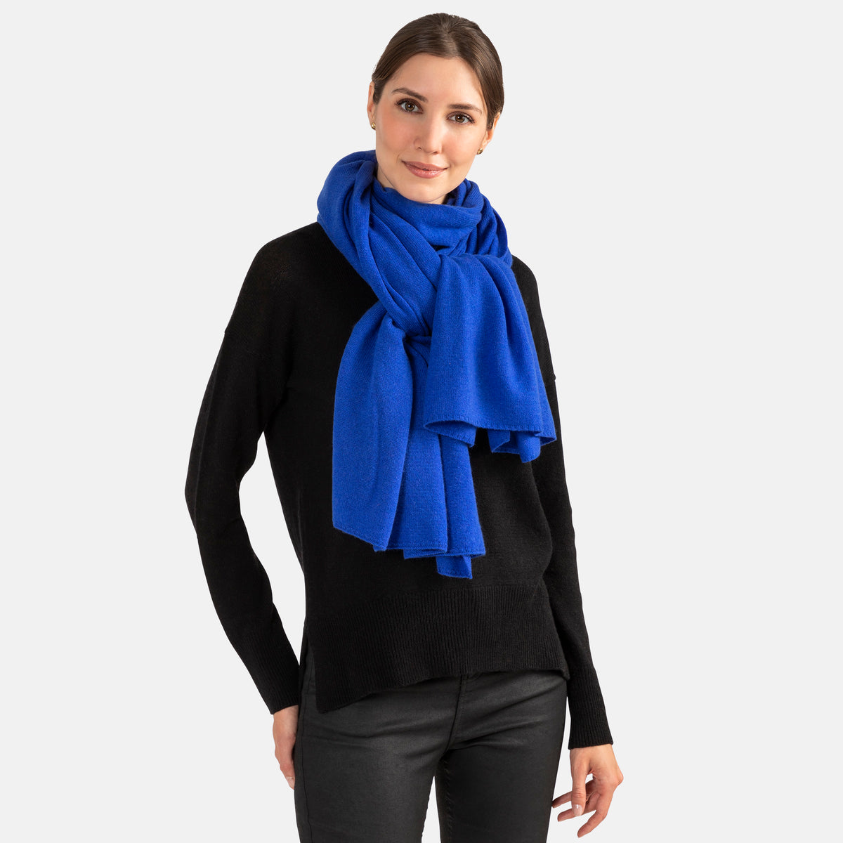 Picture of a woman wearing a cobalt blue cashmere jersey knitted oversize scarf or travel wrap.