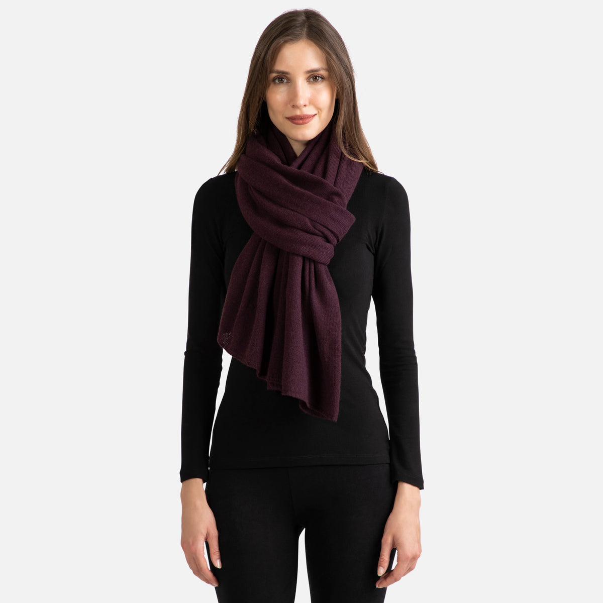 Picture of a woman wearing a dark burgundy  cashmere jersey knitted oversize scarf or travel wrap.