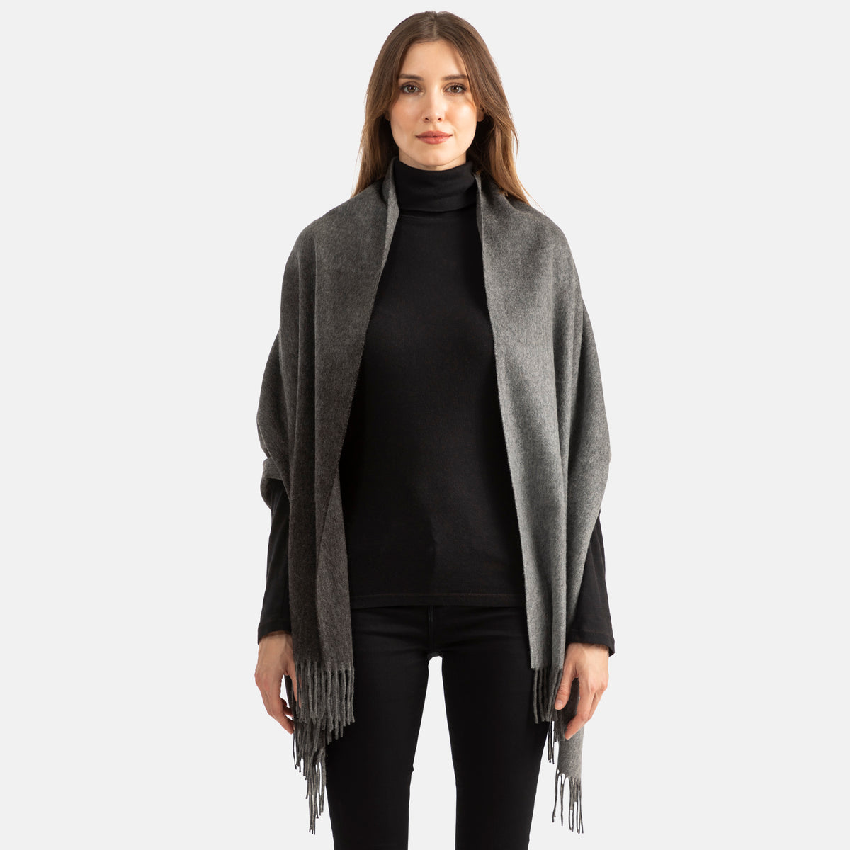 Picture of a woman wearing a double face, long woven cashmere wrap with fringe,in two tones of grey with ombre design.