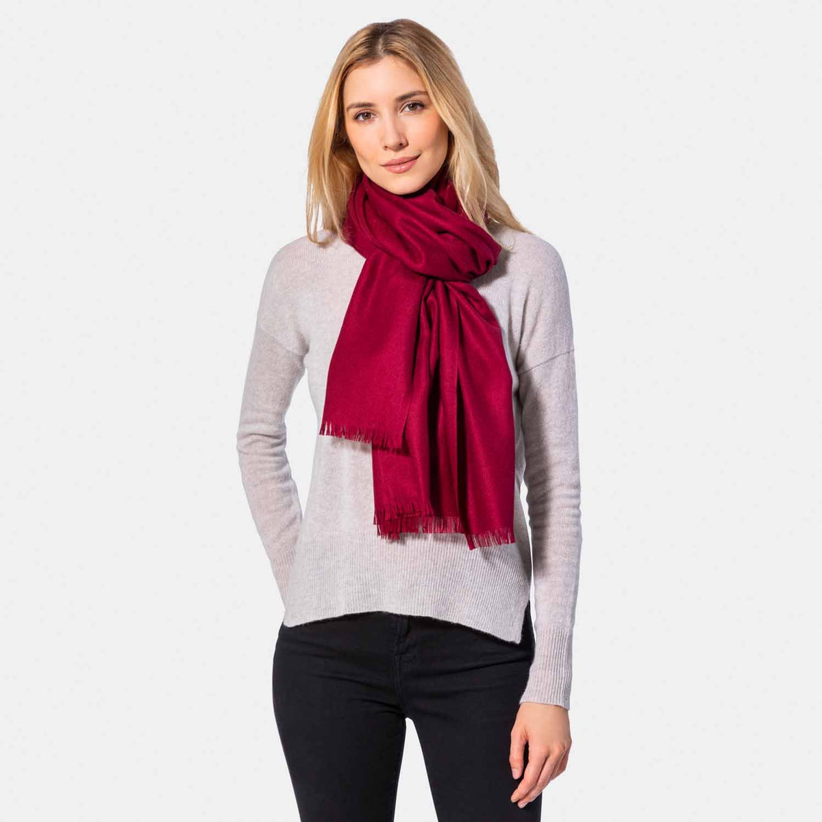 Picture of a woman wearing a cashmere blend wrap with eyelash fringe, bordeaux.
