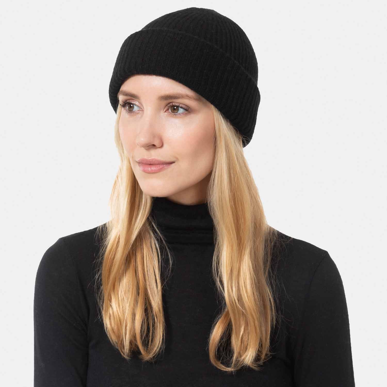 Picture of a wonan wearing a double layer rib knit hat in black.