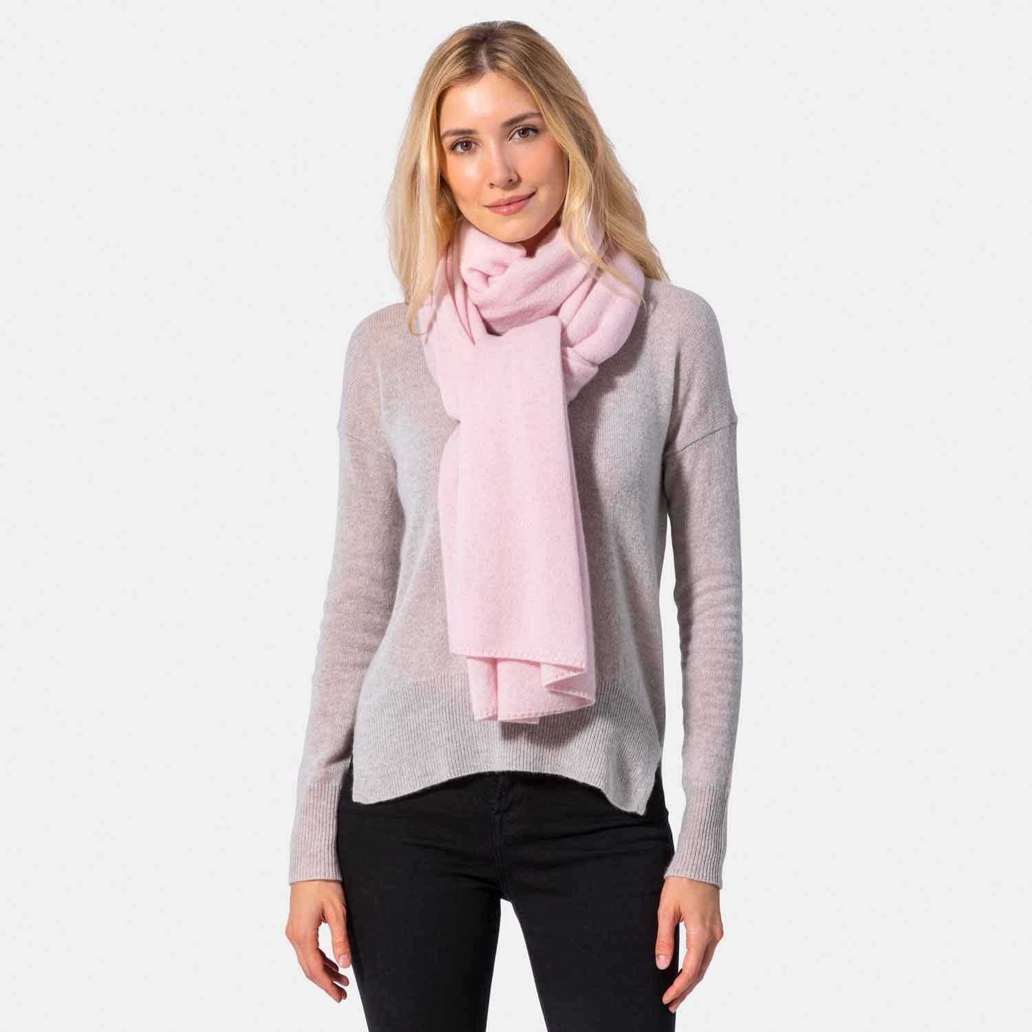 Picture of a woman wearing a grey cashmere jersey knitted oversize scarf or travel wrap.