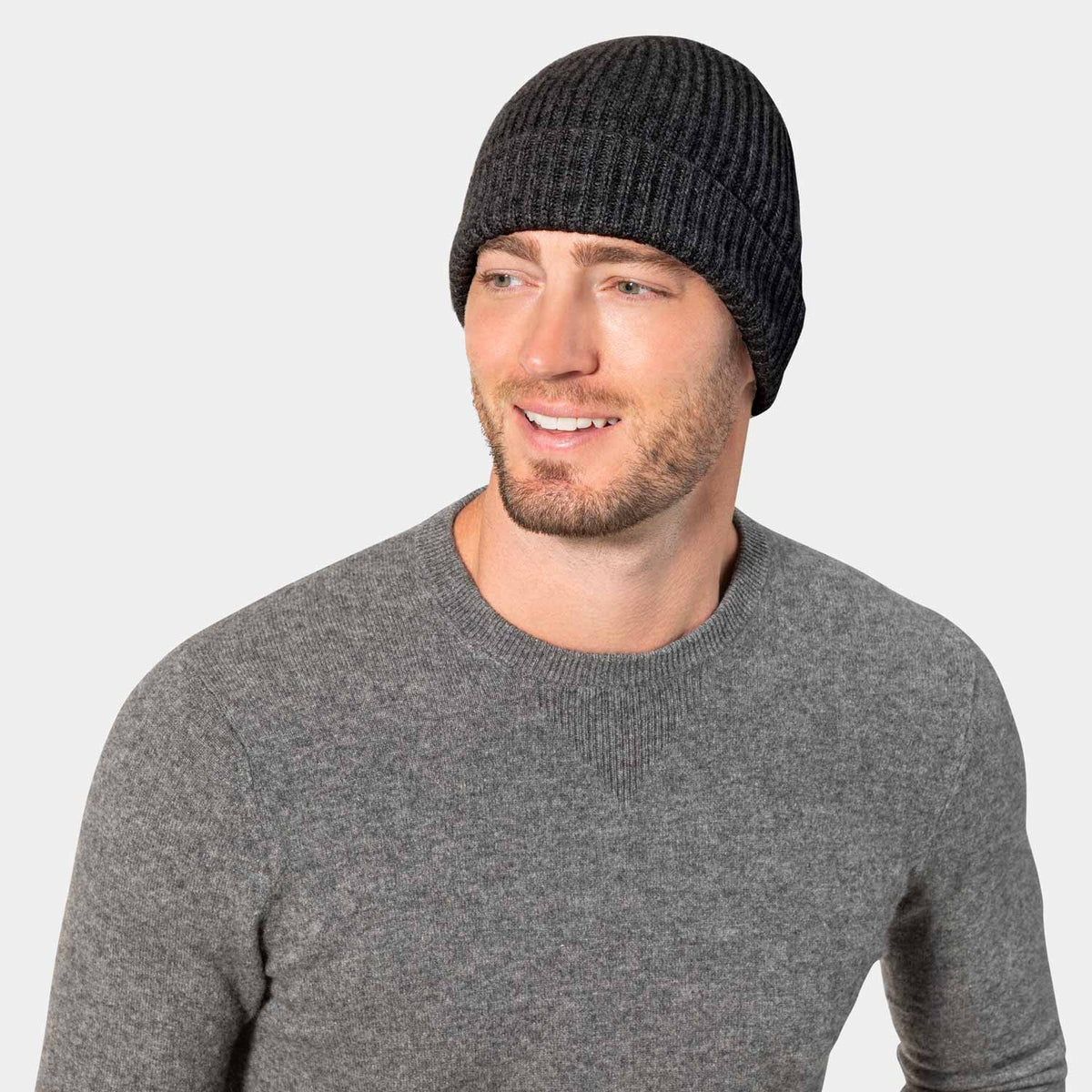Picture of a man wearing acashmere cardigan rib knit hat in oatmeal.
