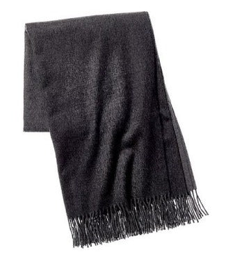 Picture of a woven wool and cashmere blend throw with twisted fringe, in a grey and cream ombre design.