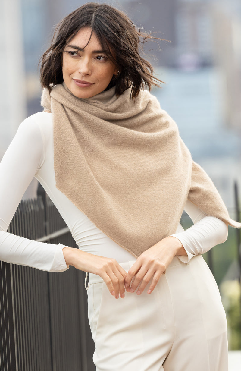 Woman wearing CASHMERE BUTTON SHOULDER PONCHO + WRAP in oat outdoors