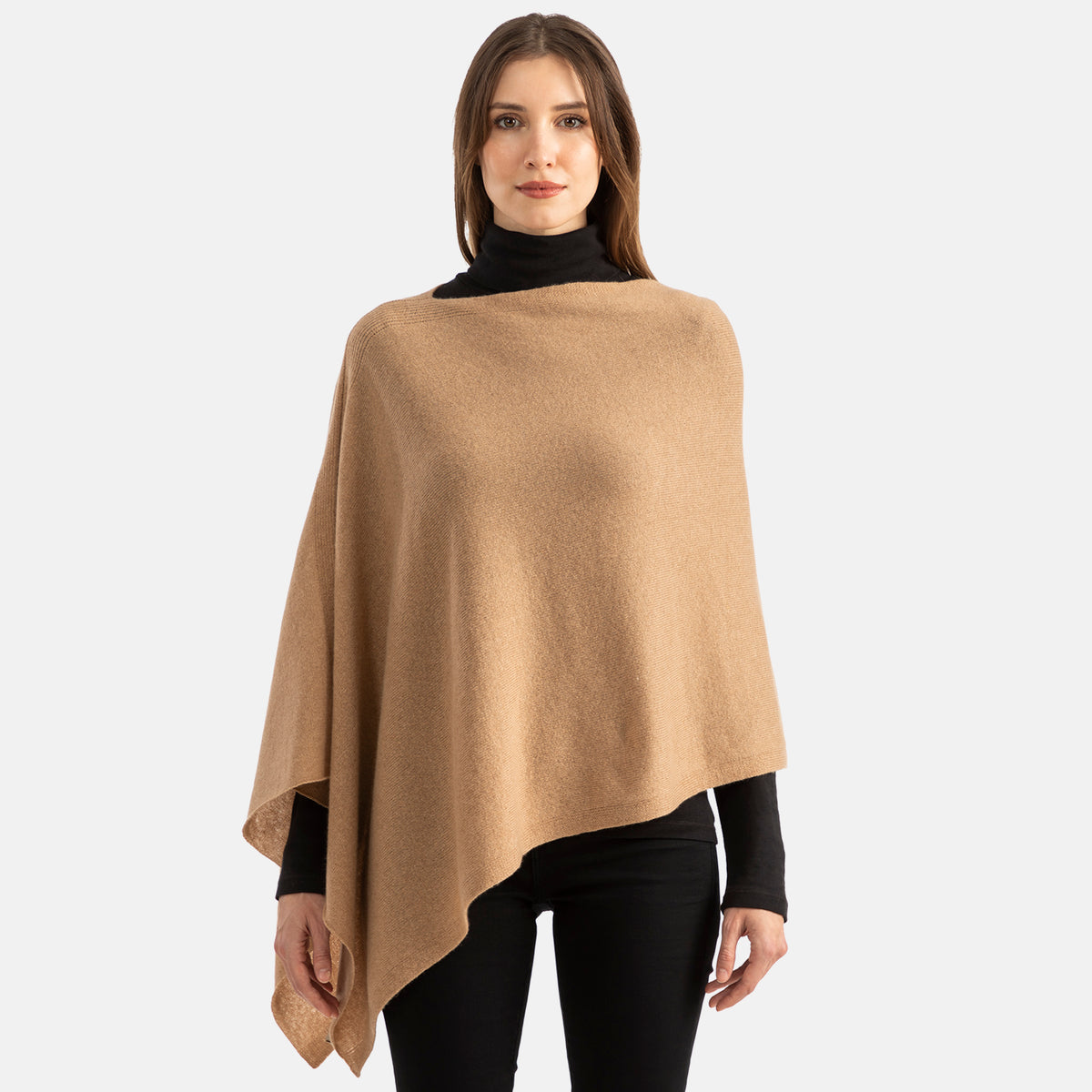 Picture of a woman wearing an asymmetrical ove the head poncho, light pink.