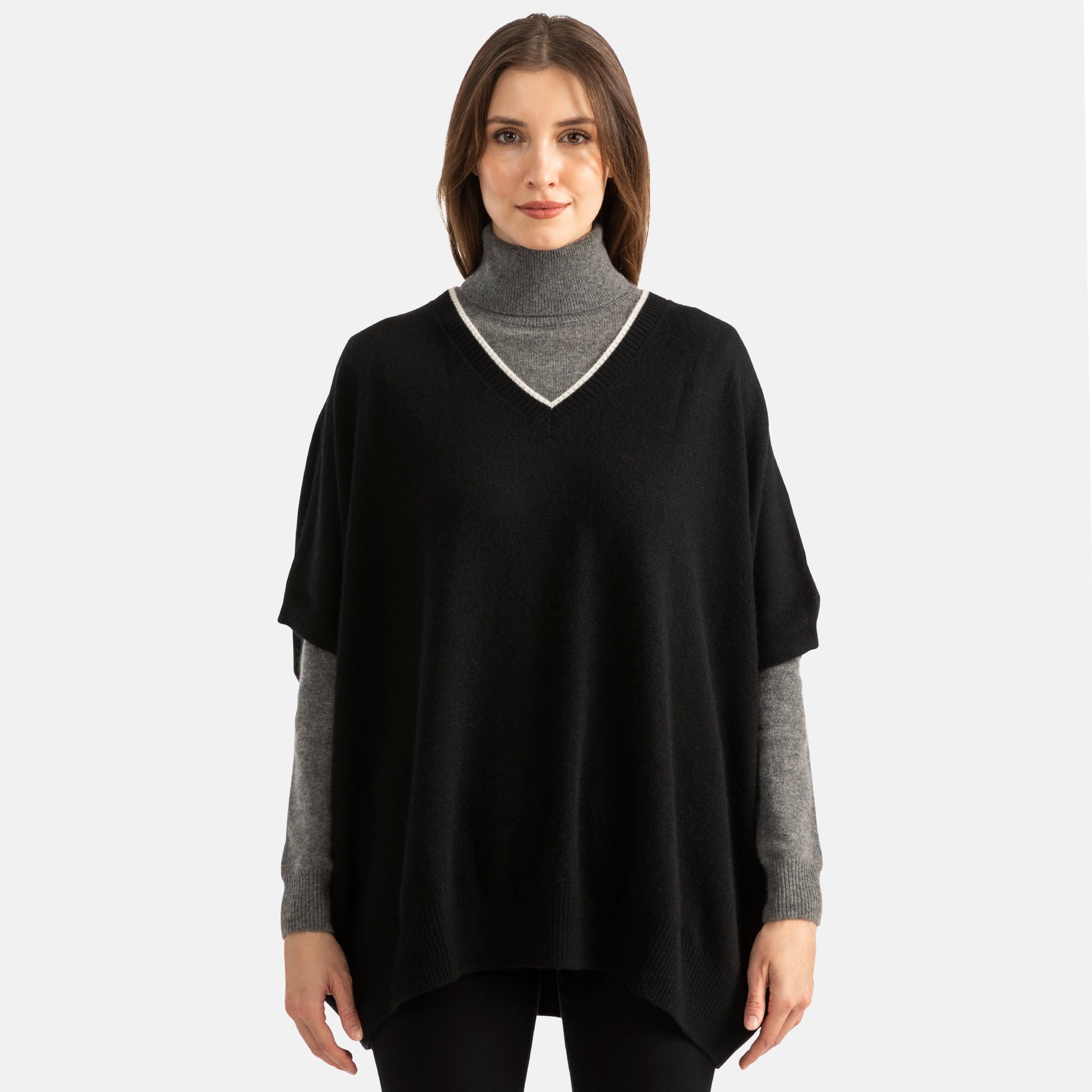 Picture of woman wearing an overhead v-neck ponch with contrast trim in grey with black trim