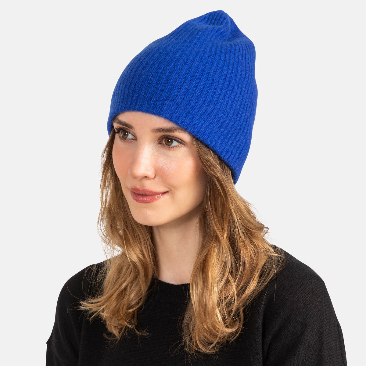 Picture of a woman wearing a double layer rib knit hat in orange.