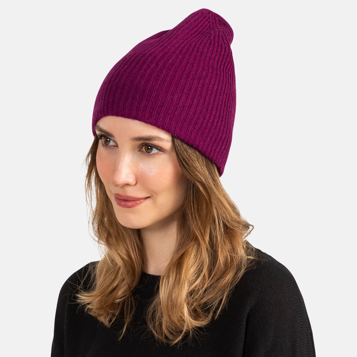 Picture of a woman wearing a double layer rib knit hat in orange.