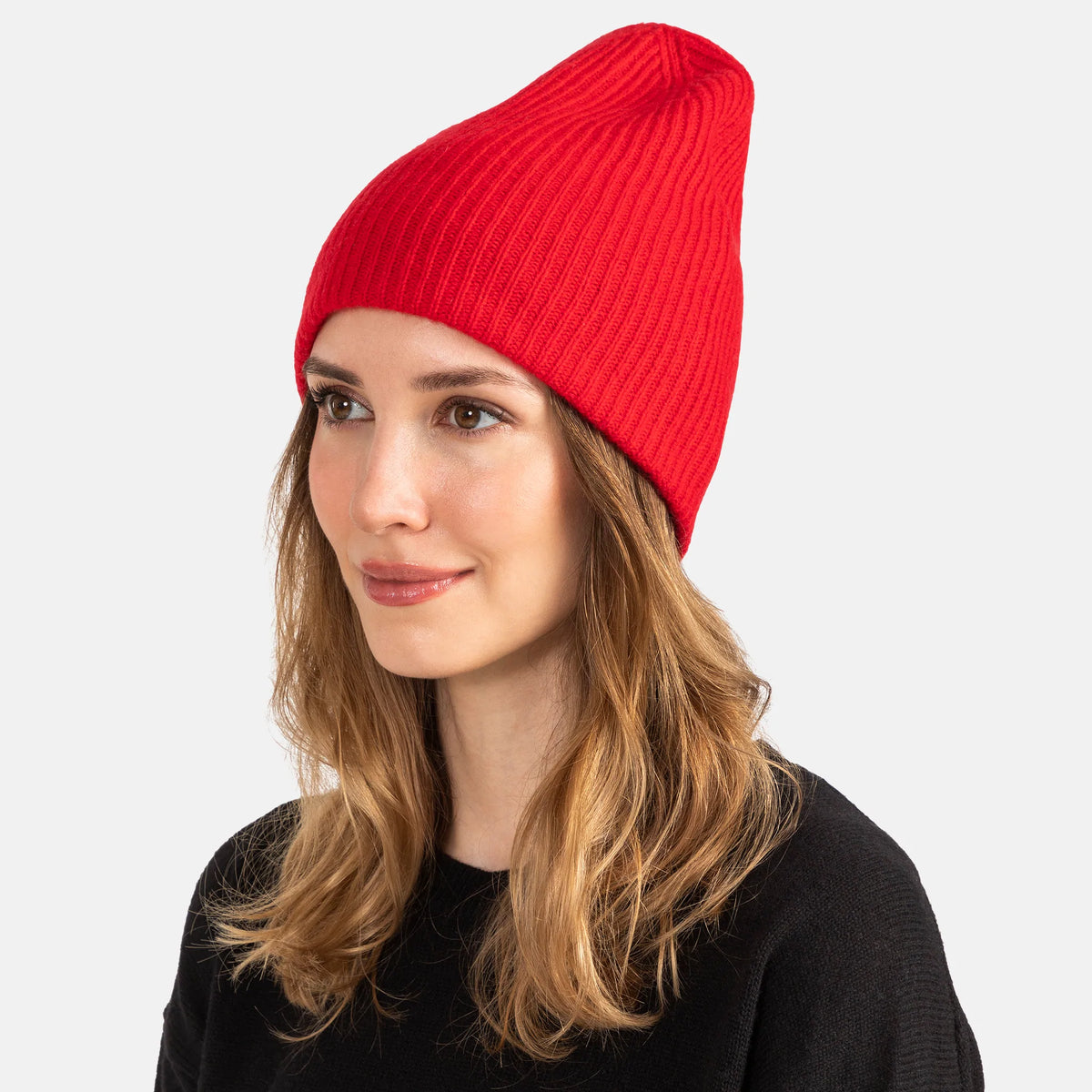 Picture of a woman wearing a double layer rib knit hat in orange.