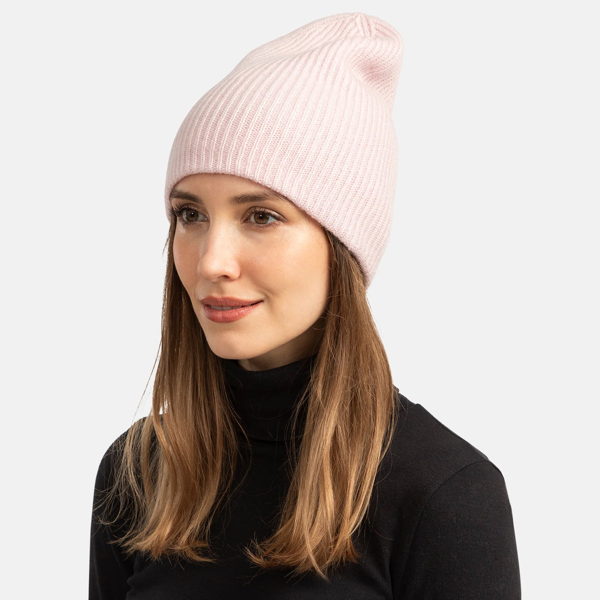 Picture of a woman wearing a double layer rib knit hat in orange.