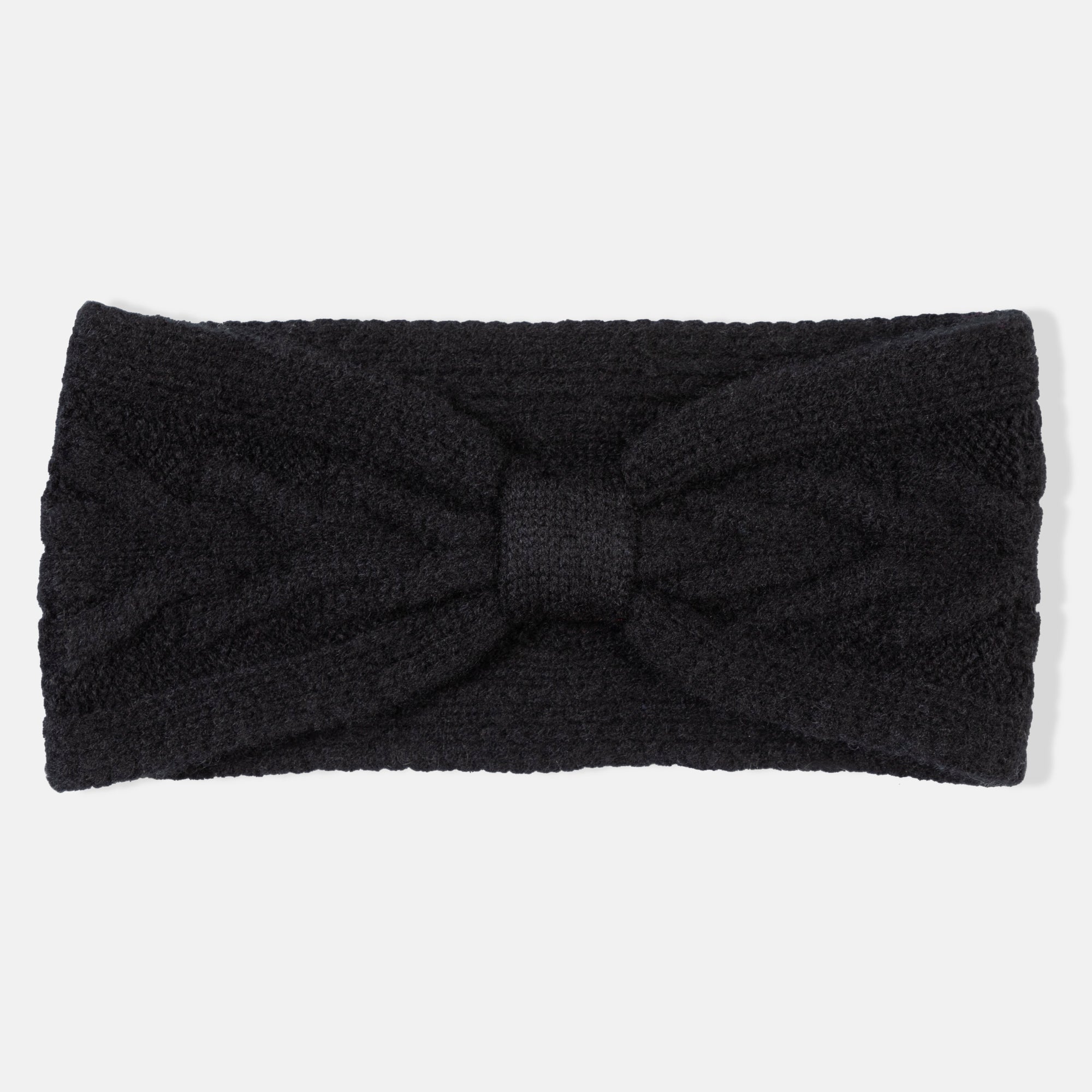 ture of a woman wearing a knitted cashmere headband with a trellis cable design in black.