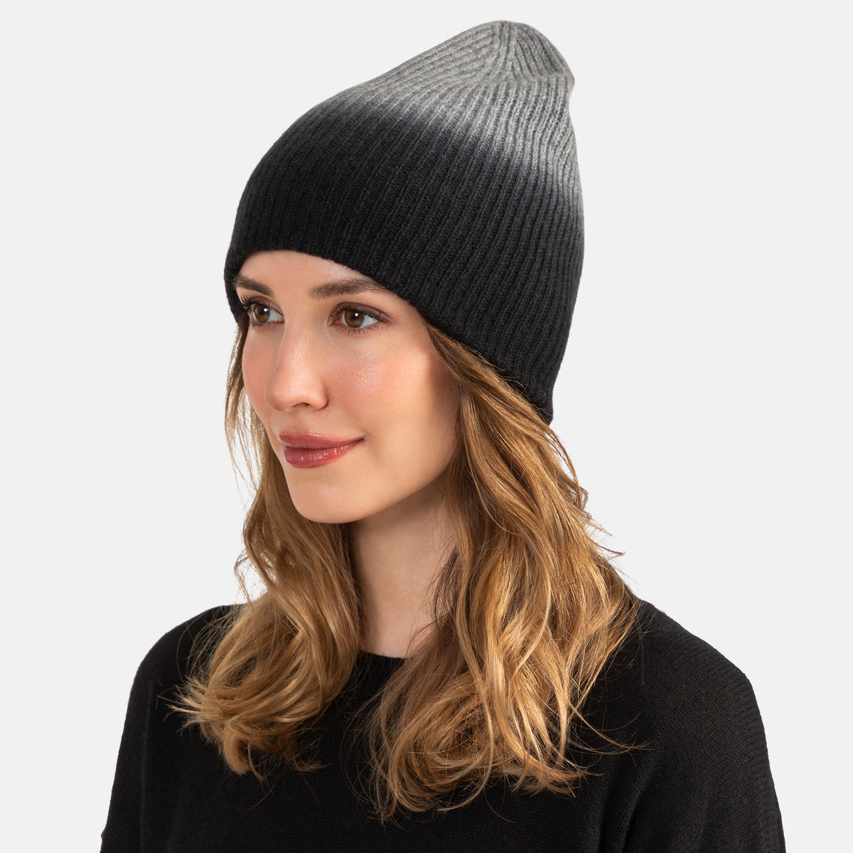 Picture of a woman in a chunky rib knit slouchy hat with an ombre design in cobalt and navy.