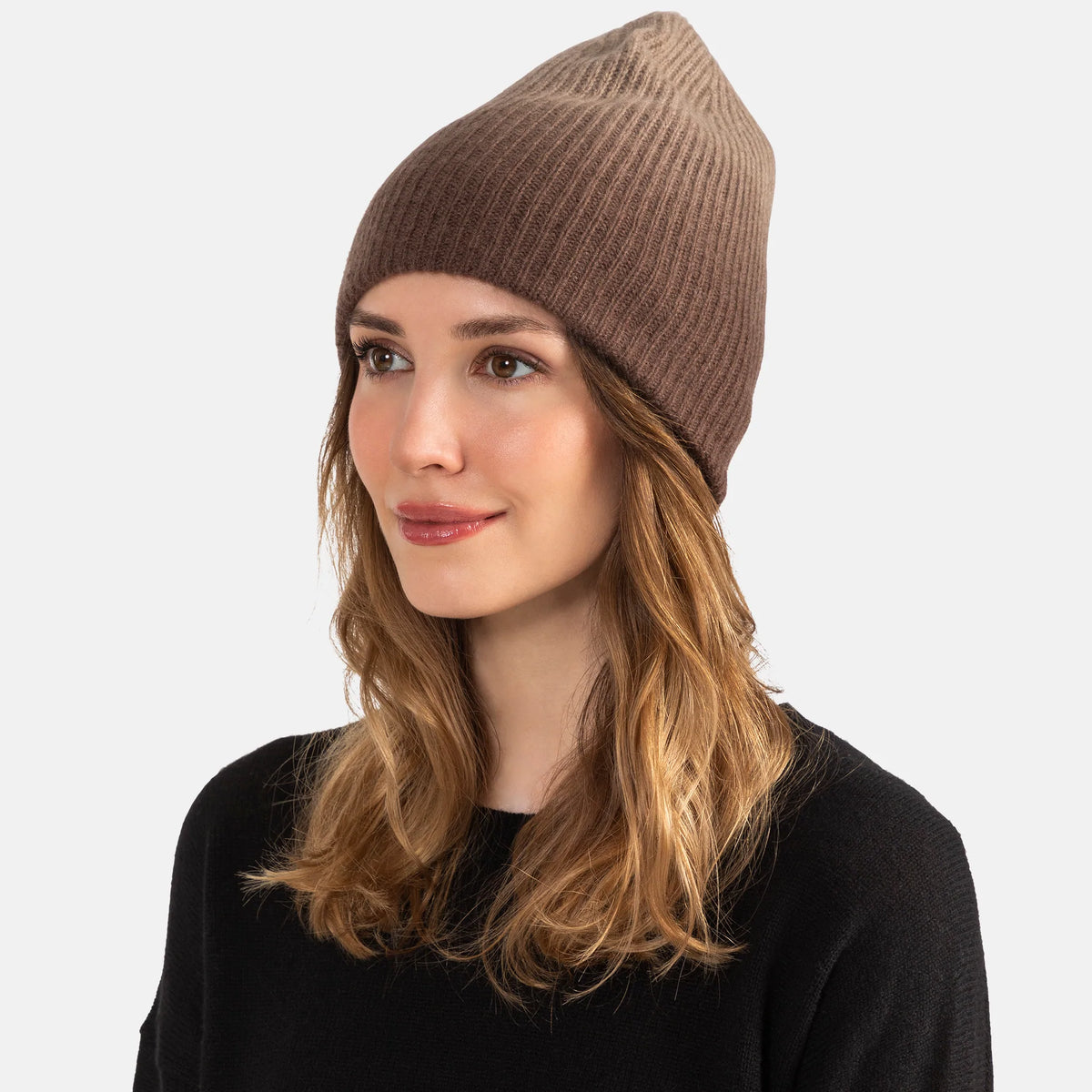 Picture of a woman in a chunky rib knit slouchy hat with an ombre design in oatmeal and tan.