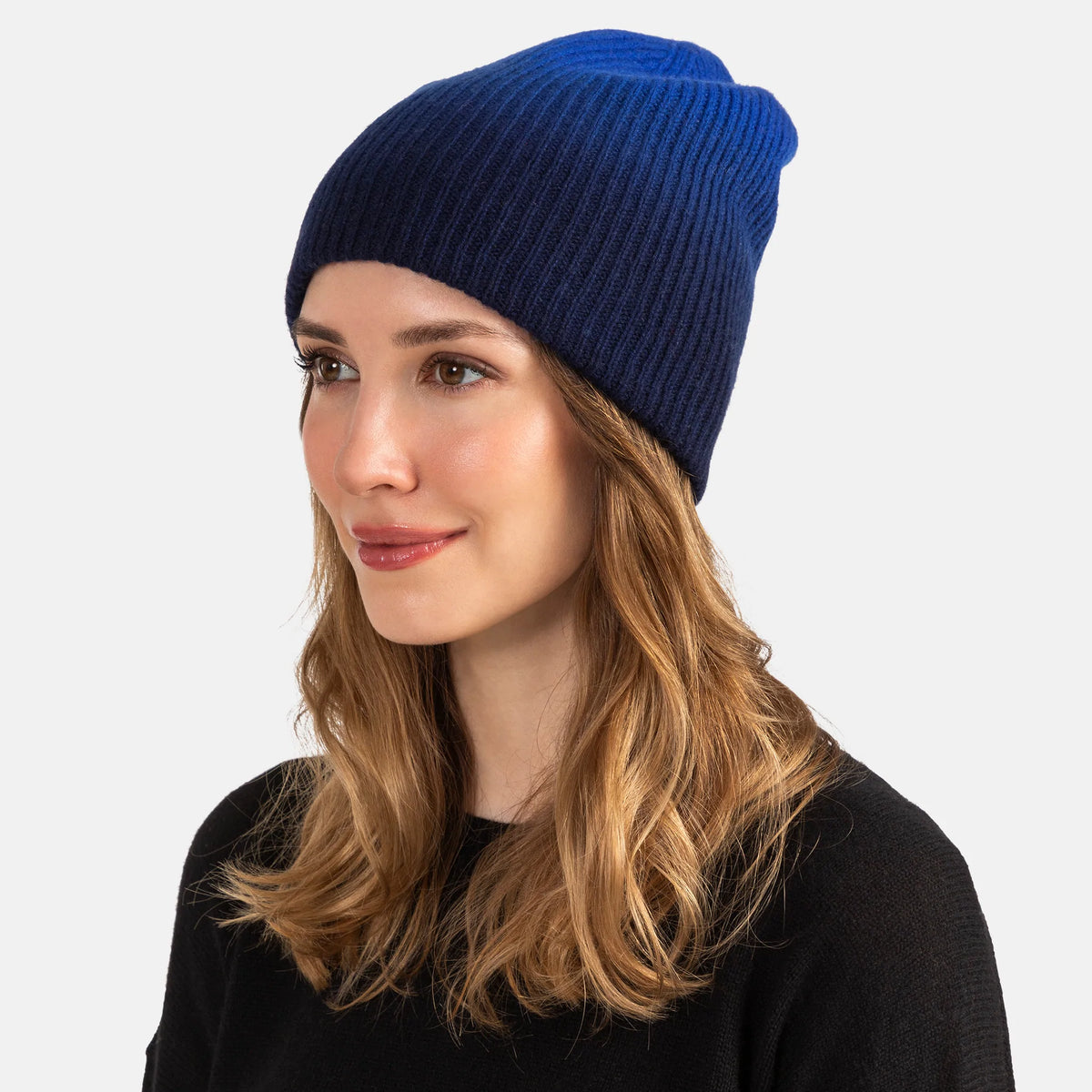 Picture of a woman in a chunky rib knit slouchy hat with an ombre design in oatmeal and tan.