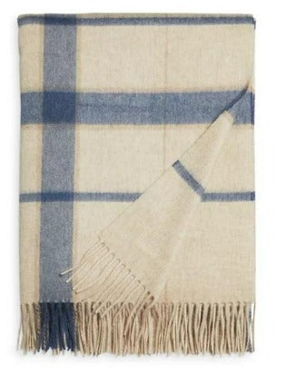 Picture of a woven cashmere throw with fringe, gray and white plaid pattern