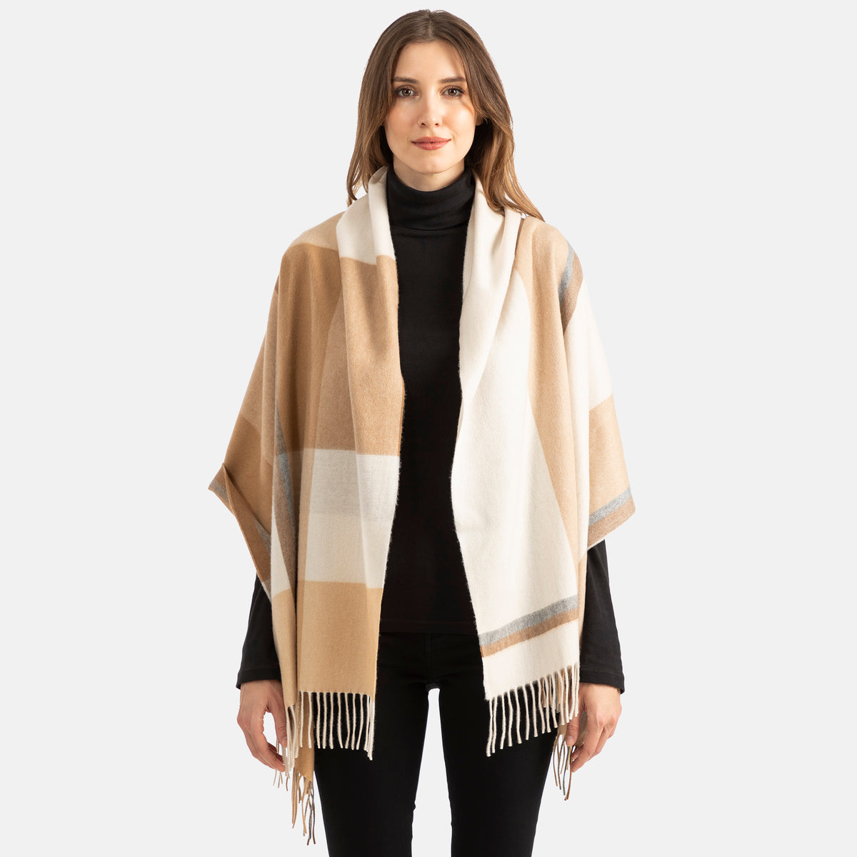 Picture of a woman wearing a colorblock plaid wrap in shades of camel and cream