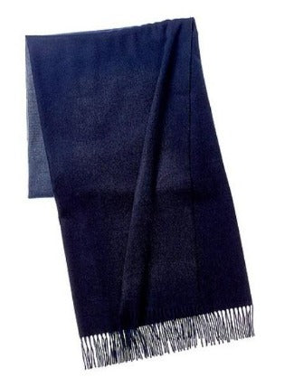 Picture of a woven wool and cashmere blend throw with twisted fringe, in a navy and cream ombre design.