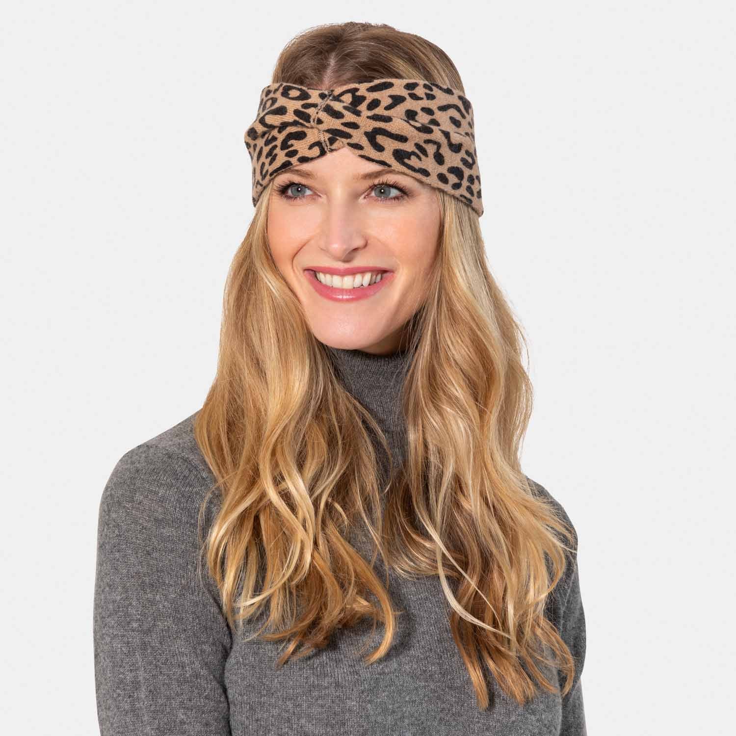 Picture of a woman in an leopard print headband camel and black.