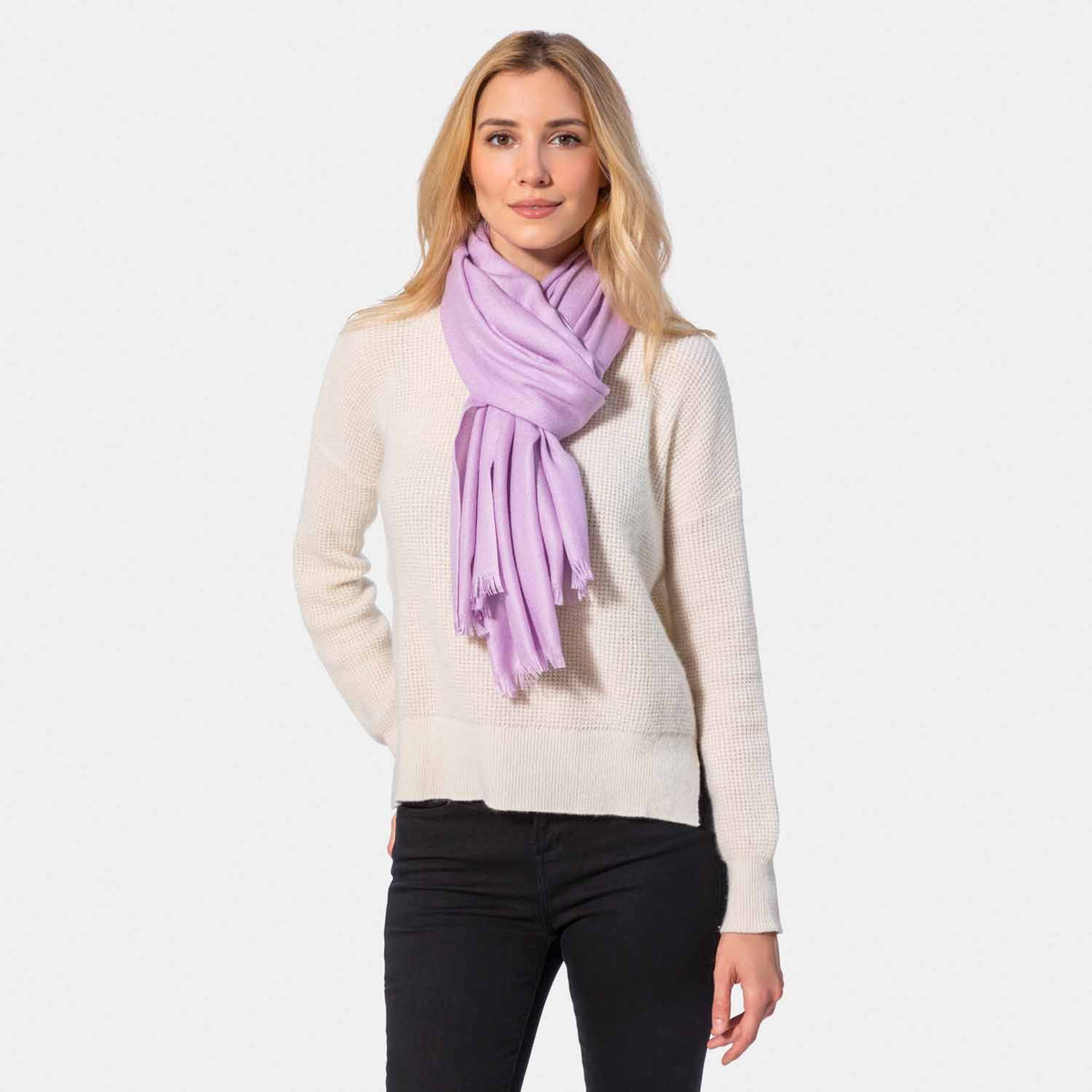 Picture of a woman in a lightweight Cashmere Blend Pashmina Wrap with Eyelash Fringe-Amicale Cashmere, orchid color.