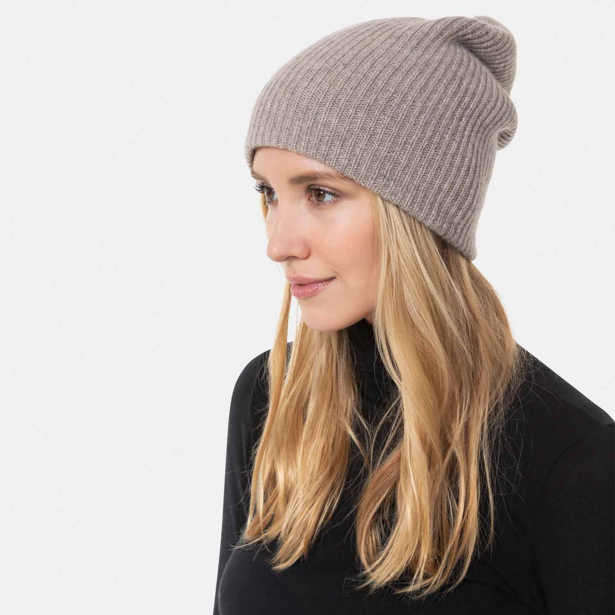 Picture of a woman wearing a double layer rib knit hat in cobalt blue.
