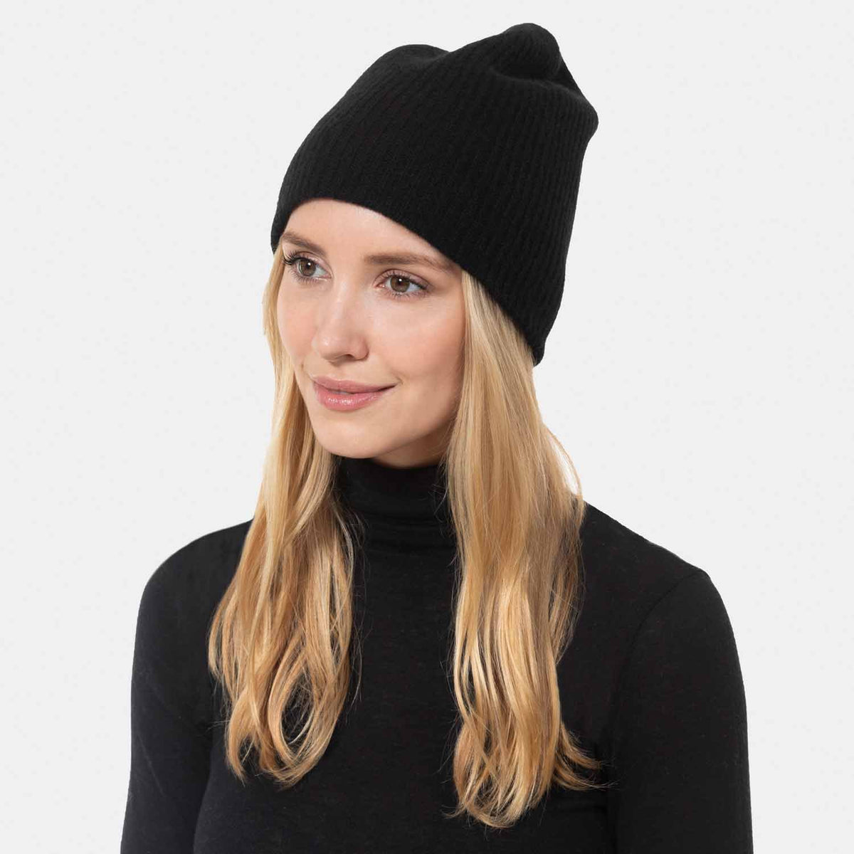Picture of a woman wearing a double layer rib knit hat in grey.