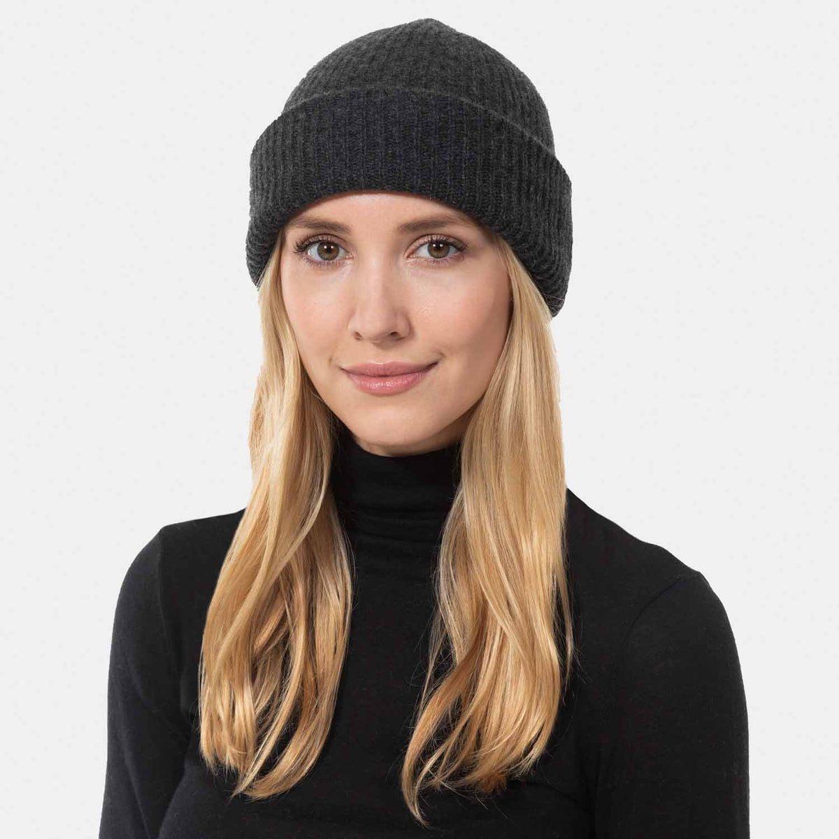 Picture of a woman wearing a double layer rib knit hat in camel.