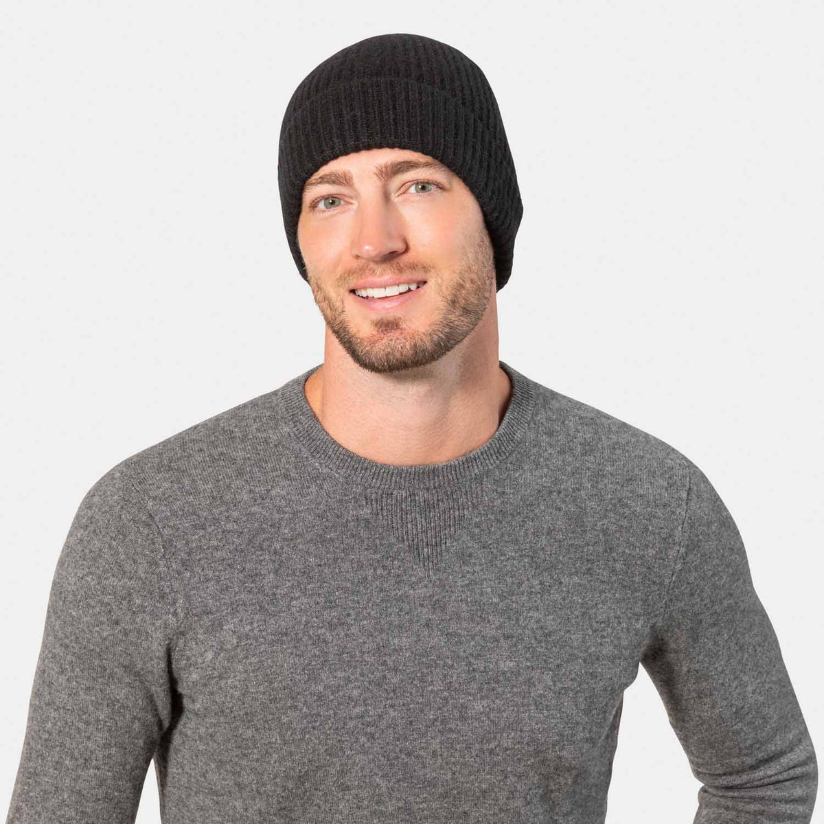 Picture of a man wearing acashmere cardigan rib knit hat in charcoal.
