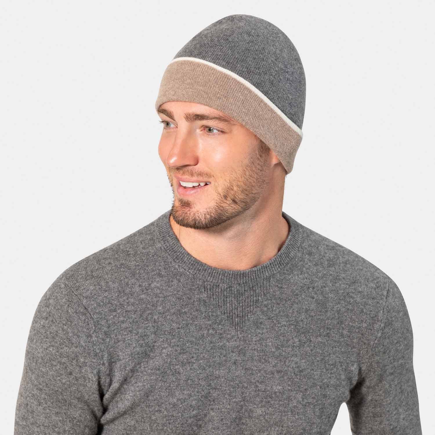 Picture of a man wearing a reversible cashmere knit jat with cuff in tan and grey.