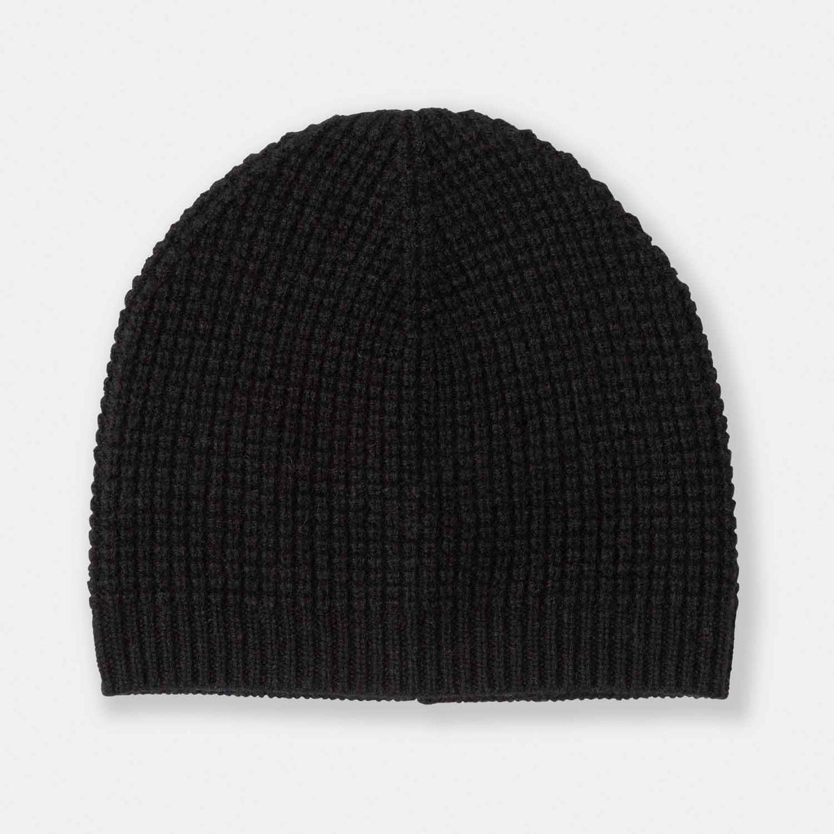 Picture of a man wearing a waffle knit cuffed hat in charcoal.