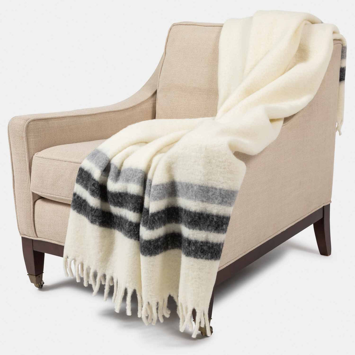 Picture of a mohair throw with fringe in camel  with grey stripes